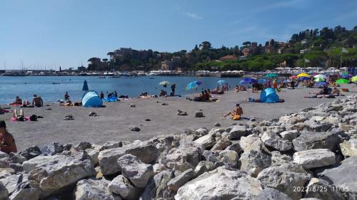 a group of people on a beach with rocks at I love Rapallo La casa AlMar in Rapallo