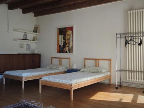 two beds sitting in a room with at La Corte del Noce in Zanica