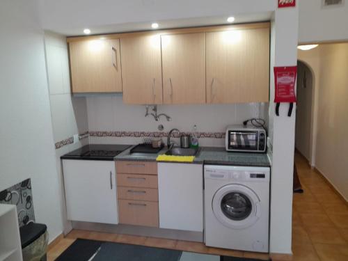 eine Küche mit Waschmaschine in der Unterkunft Apartamento Maria do Céu Villa Magna in Albufeira