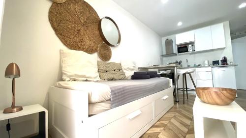 a bedroom with a bed with a mirror on the wall at Studio Bricka - 200m to the beach, parking, clim, terrace in Antibes
