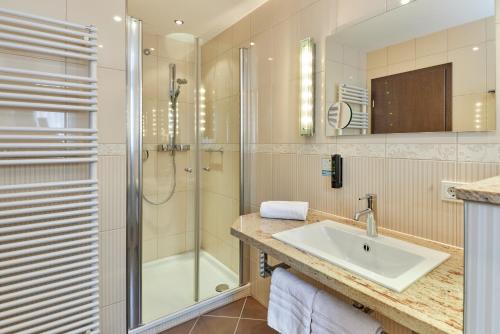 a bathroom with a sink and a shower at Hotel Sankt Maximilian in Bernkastel-Kues