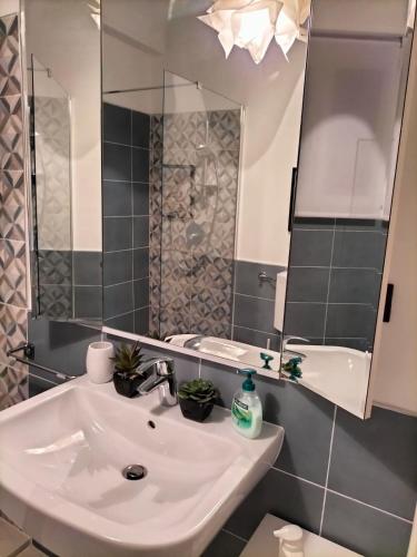 a bathroom with a sink and a mirror at Attico con vista mozzafiato in Bordighera