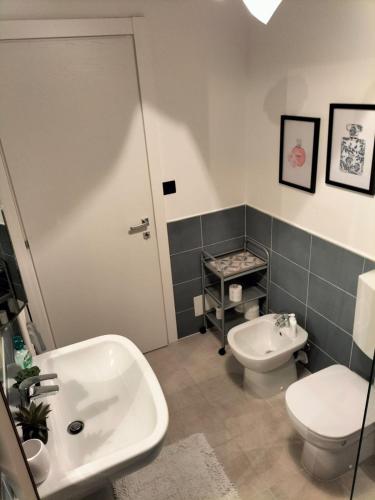 a bathroom with a toilet and a sink at Attico con vista mozzafiato in Bordighera