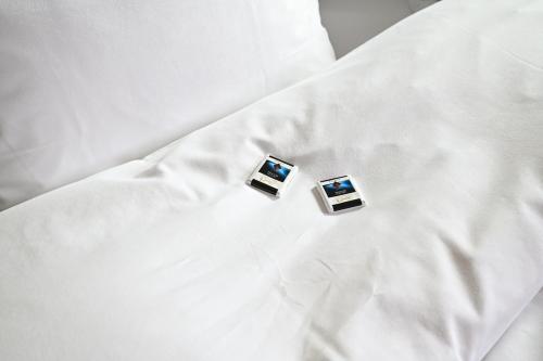 two pictures are sitting on a white sheet at Boato Bistrot & Bed in Tegna