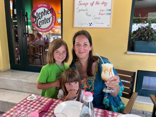 a woman and two children sitting at a table at Stephen Center B&B in Tirana