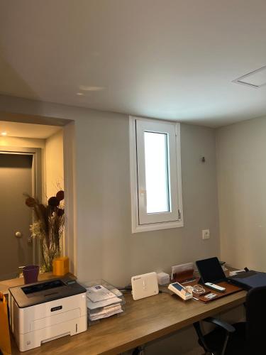 an office with a desk with a printer and a window at Grimani Pension in Nafplio