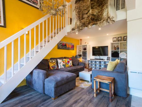d'un salon avec des murs jaunes et un escalier. dans l'établissement Ski-in/ski-out & pool: great for summer and winter, à Saint-Gervais-les-Bains