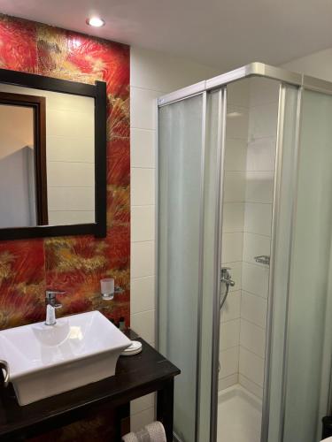 a bathroom with a sink and a shower at Grimani Pension in Nafplio