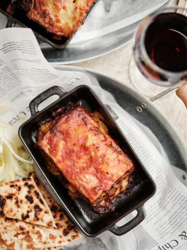 a pan filled with food and a plate of pizza at Linton Lodge a BW Signature Collection Hotel in Oxford