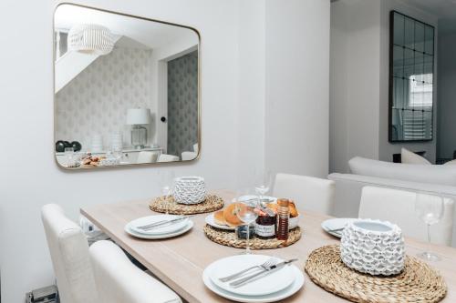 ein Esszimmer mit einem Tisch und einem Spiegel in der Unterkunft The Dragonfly - Central 2 bedroom house in Henley on Thames