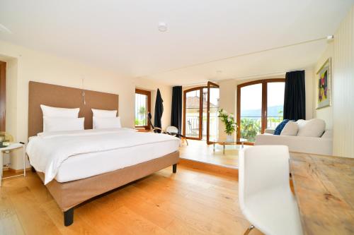 a bedroom with a large bed and a living room at Boato Bistrot & Bed in Tegna