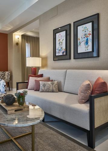 a living room with a couch and a table at Vincci Molviedro Suites Apartments in Seville