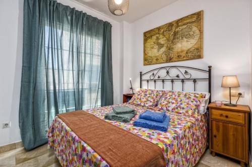 a bedroom with a bed with blue pillows on it at Fuengirola center, 3 bedrooms, and parking in Fuengirola