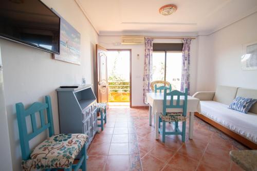 a living room with a couch and a table and chairs at Apartamentos Turisticos Trajano in Bolonia