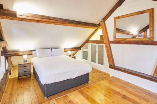 a bedroom with a white bed and a mirror at Host & Stay - The Duck Pond in Durham