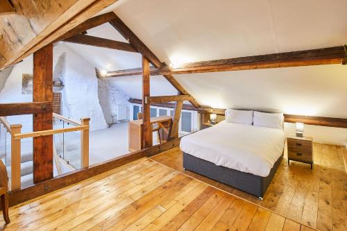 a bedroom with a bed in a room with wooden floors at Host & Stay - The Duck Pond in Durham