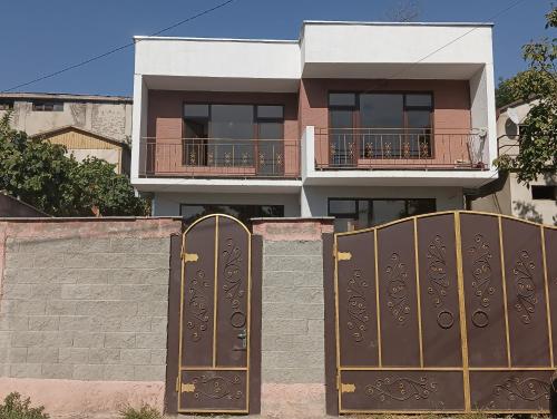 a house with a bunch of gates in front of it at Mary's Cozy & Lovely studio on very quiet Khosharauli street in Tbilisi City