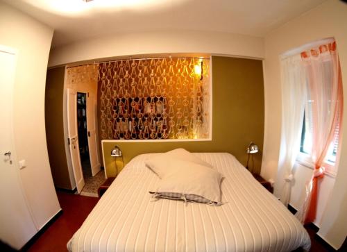 a bedroom with a bed with a wall with wine glasses at BBQ Lodge in Camogli