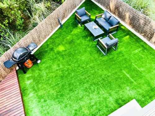 an overhead view of a lawn with chairs and a table at Villa PAM, ALYA Beach House with pool and Hot Tub in Alcudia