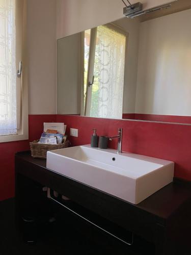 y baño con lavabo blanco y espejo. en Villa Arzilla, en Desenzano del Garda