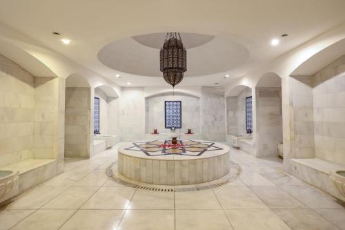 a large bathroom with a large round table in the middle at Crystal Prestige Elite in Kemer