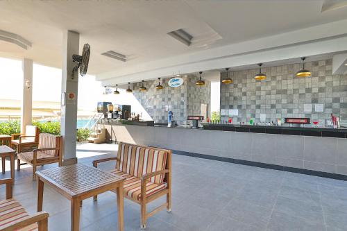 a restaurant with a bar with chairs and a counter at Crystal Prestige Elite in Kemer