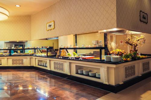 a restaurant kitchen with a counter with food at Crystal Prestige Elite in Kemer