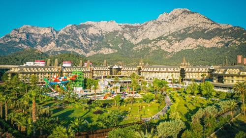 a city with a park with mountains in the background at Crystal Prestige Elite in Kemer