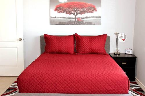 a red bed in a bedroom with a red tree at Spacious Home, Short Walk to Beach, Heated Pool! in Corpus Christi