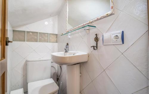 a bathroom with a sink and a toilet and a mirror at Stunning Home In Gaucin With Wifi in Gaucín