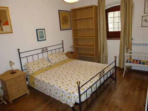 a bedroom with a bed and a book shelf at Nebojsega b&b in Santa Croce Mare