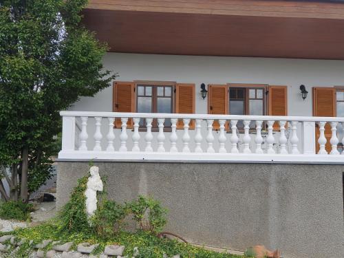 a white balcony on the side of a house at Ferienhaus Panorama in Rechnitz