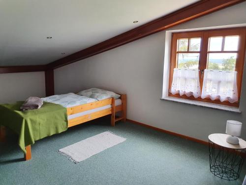 a bedroom with a bed and a window at Ferienhaus Panorama in Rechnitz