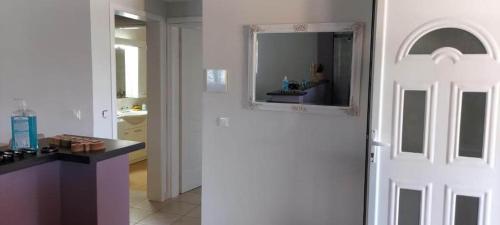 a white door in a kitchen with a mirror at Evelina's suite in Artemida