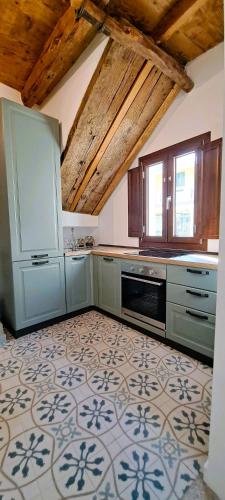 a kitchen with blue cabinets and a tile floor at Civico Otto7 in Villasimius