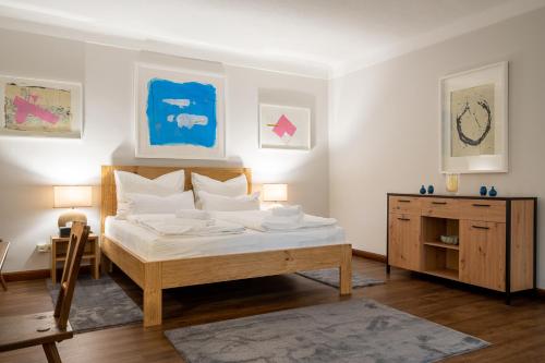 a bedroom with a bed and a dresser in it at Gästehaus Golf Club Gut Murstätten in Lebring