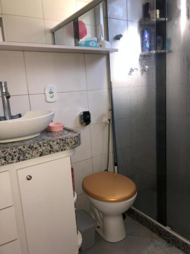 a small bathroom with a toilet and a sink at Charmosa suíte com vista lateral mar ! in Rio de Janeiro