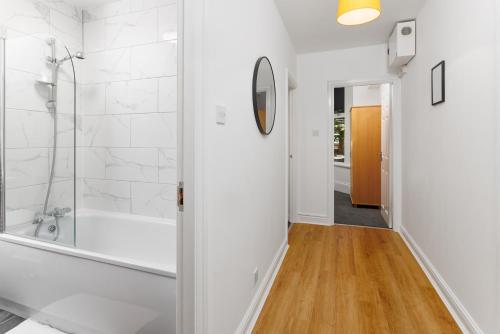a bathroom with a shower and a walk in shower at FLATZY - Lovely Sefton Park Retreat in Liverpool