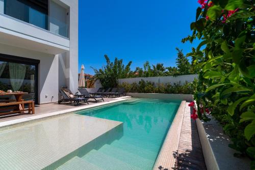 a swimming pool in the backyard of a house at Thalassa Luxury Villa in Ialysos