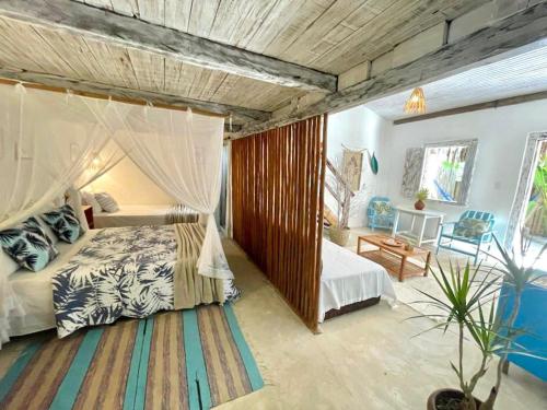a bedroom with a bed with a mosquito net at VILA TRANCOSEAR in Trancoso