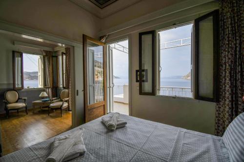 a bedroom with a bed with a view of the ocean at anoi tholos in Symi