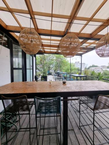 a patio with a table and chairs and chandeliers at Metro Hostal Boutique in Mexico City