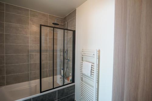 a bathroom with a shower with a glass shower stall at The Azalea beautiful quiet apartment for 4 people! in Doussard