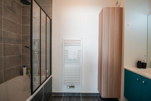 a bathroom with a shower with a glass door at The Azalea beautiful quiet apartment for 4 people! in Doussard