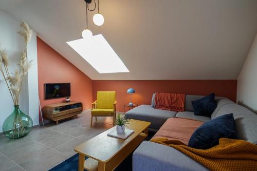 ein Wohnzimmer mit einem Sofa und einem Tisch in der Unterkunft The Azalea beautiful quiet apartment for 4 people! in Doussard