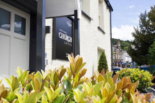 a sign on the side of a building at Church Suites by The Cranleigh Boutique in Bowness-on-Windermere