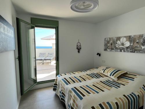 a bedroom with a bed and a view of the ocean at Lovely New Luxery Beach Apartment in Mojacar Playa in Mojácar