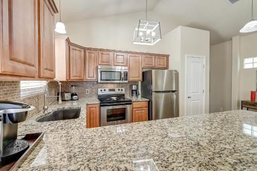 a kitchen with wooden cabinets and stainless steel appliances at Marquesas #310 in Padre Island