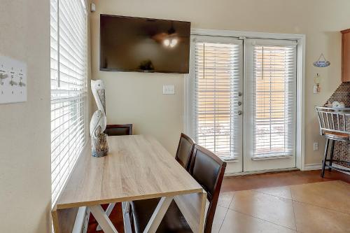 a dining room with a wooden table and chairs at Marquesas #310 in Padre Island