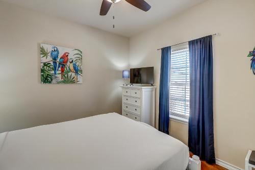 a bedroom with a bed and a ceiling fan at Marquesas #310 in Padre Island